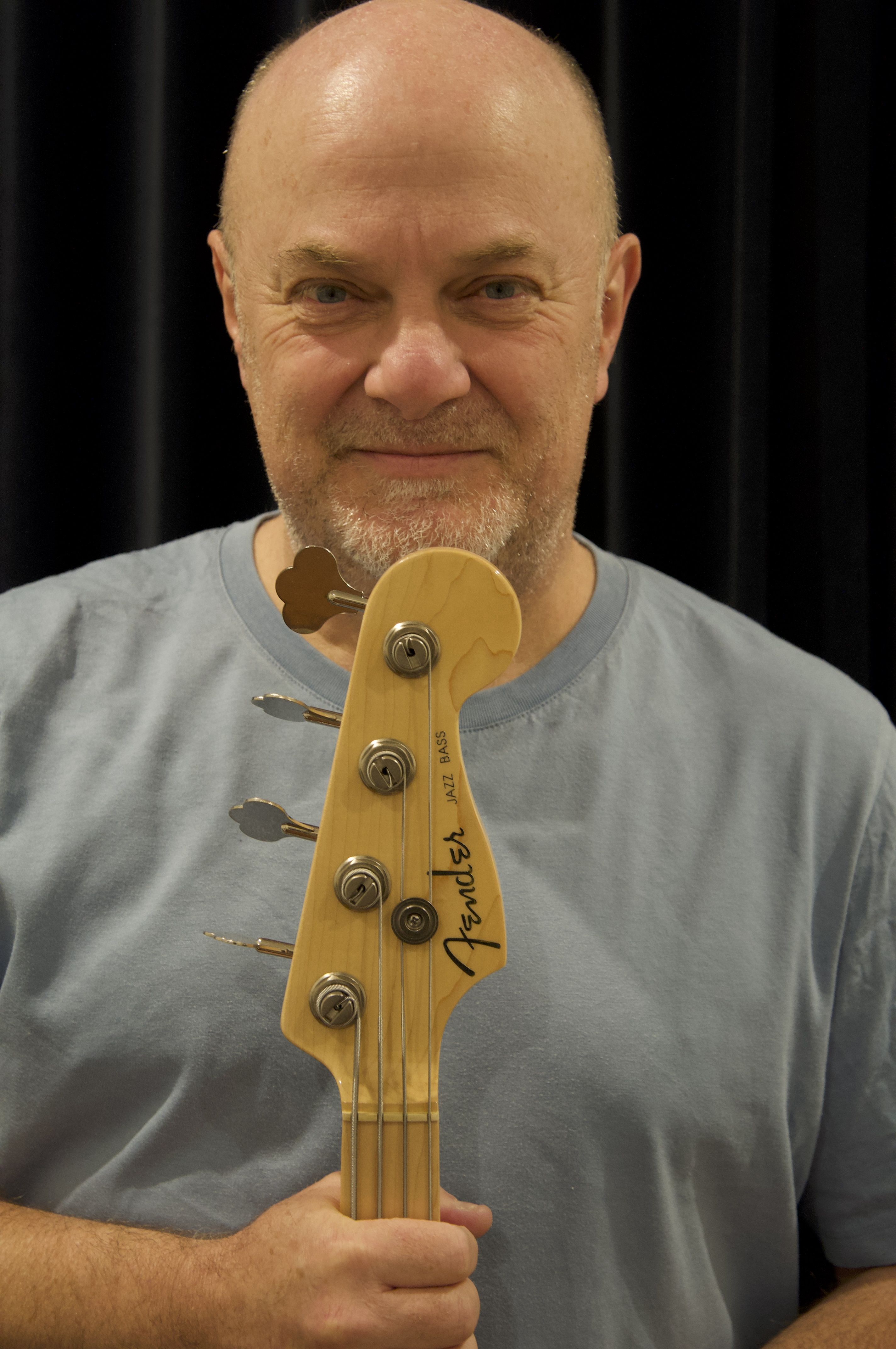 Nick Airey holding an electric bass